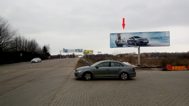 Щит 6x3,  Кільцева дорога, на перетині з Шухевича Р. вул., ліва (Гіпермарткет "Епіцентр", Гіпермаркет "МЕТРО", АЗС "БРСМ-нафта", в'їзд до автосалонів "BMW", "HONDA", "Volkswagen & Seat"), в напрямку Шевченка ву